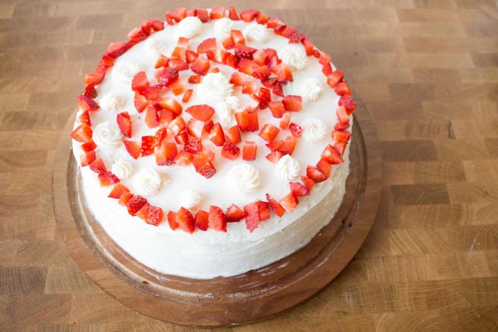 Strawberry cake with prosecco frosting is light and fluffy, just the right amount of sweet, and the perfect sweet bite of spring!