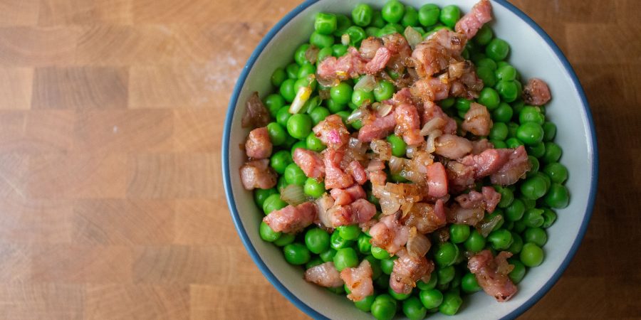 Peas with pancetta are the perfect easy side dish! The pancetta makes them seem elegant, but they're simple enough to toss together in ten minutes!