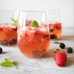 Berry rosé sangria is the perfect picnic sip! It's perfect to take on a day trip to the lake or the park, or just for a summer evening! | Teaspoon of Nose