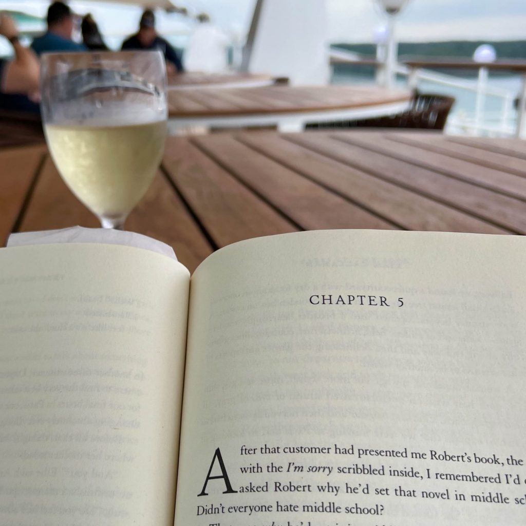 Reading a book outside with a wine glass best novels of 2023